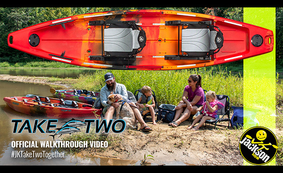 Family sitting around kayaks.