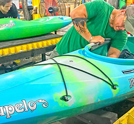 Person working on a kayak.