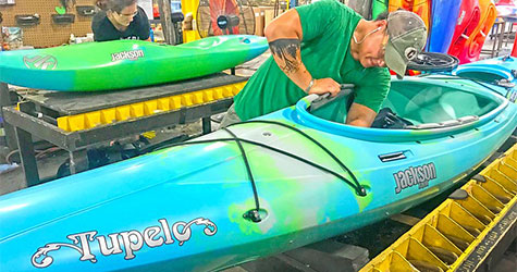 Person working on a kayak for mobile screens.