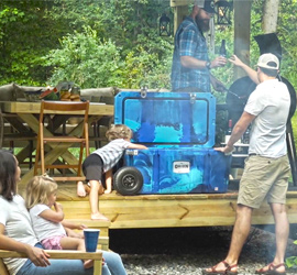 People around an Orion Cooler at a cookout.