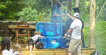 People around an Orion Cooler at a cookout for mobile.