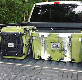 Orion Kennel and Cooler in the back of a truck.