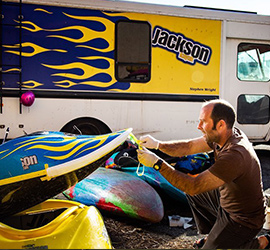 Person working on a kayak.